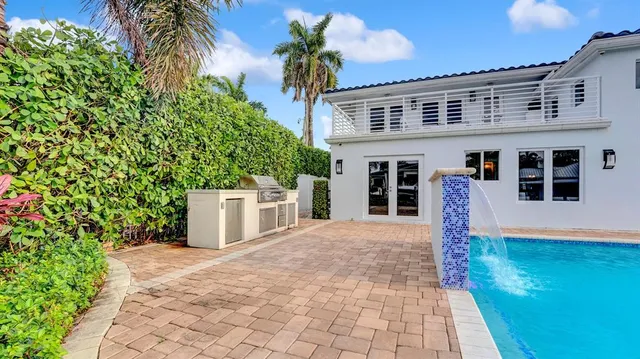 a view of a house with backyard porch and sitting area