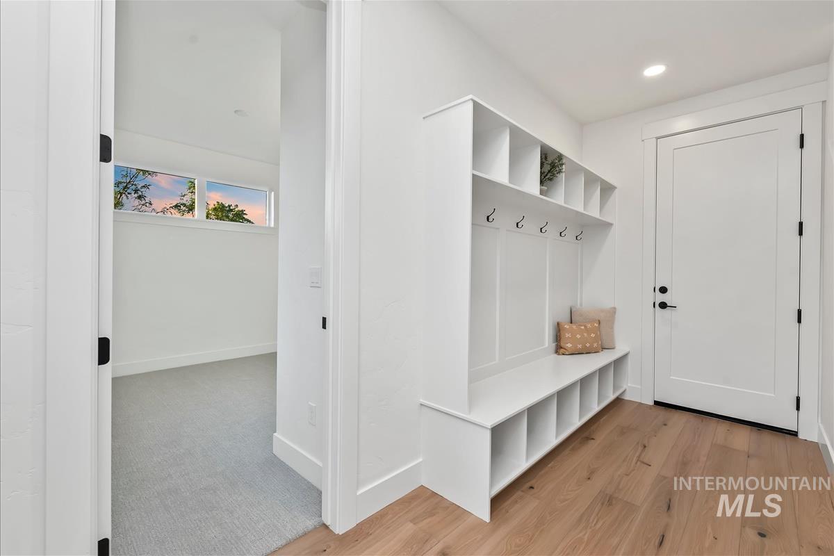 3219 West Moore Street Boise, ID 83702 - Photo 5 of 36 Entryway featuring a built-in white mudroom bench with cubby storage, upper shelving, and coat hooks