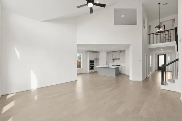 a view of a kitchen with furniture and a ceiling fan