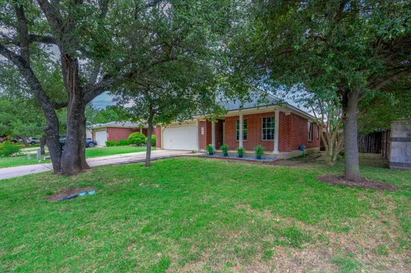 a view of a house with a backyard