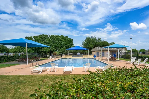 a view of a house with swimming pool and sitting area