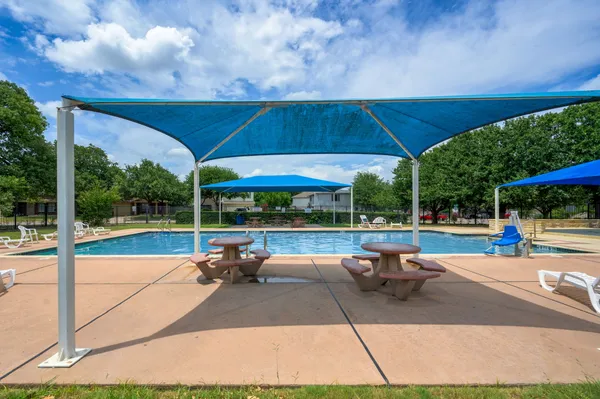 a view of a patio with a table and chairs under an umbrella