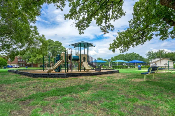 a view of a park with large trees