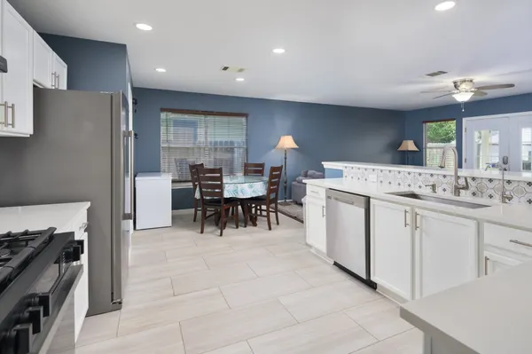 a kitchen with a sink stove and refrigerator