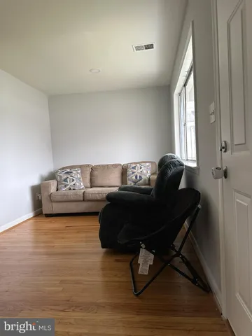 a living room with furniture and a mirror