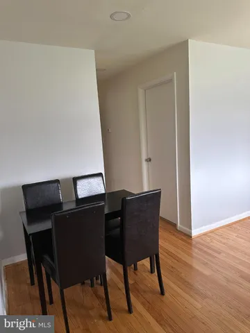 a view of a workspace with furniture and wooden floor