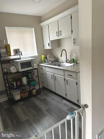 a kitchen with stainless steel appliances a sink and cabinets