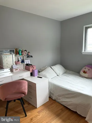 a bedroom with a bed a desk and chair