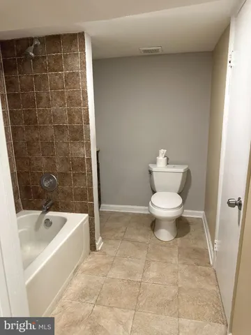 a bathroom with a toilet and a bathtub