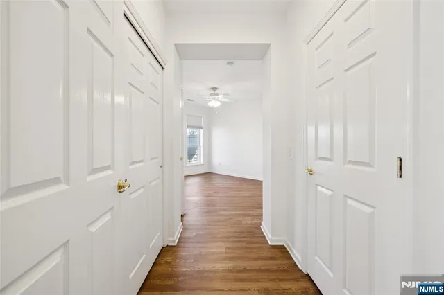 a view of a hallway with wooden floor