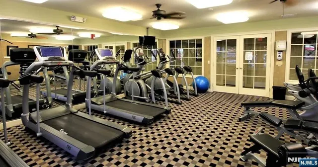 a room with lots of chairs and mirrors