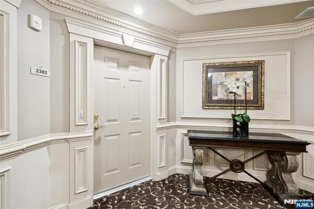 a living room with a table and a potted plant