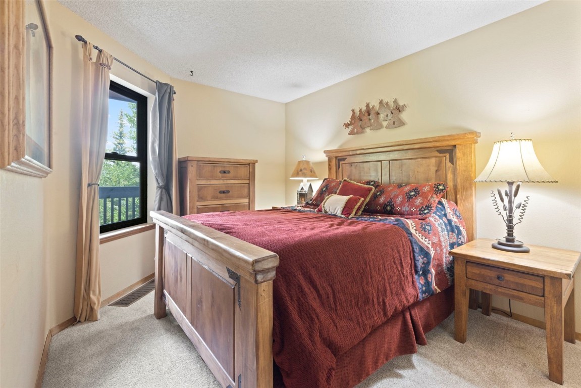 570 Bills Ranch Road, Unit 325 Frisco, CO 80443 - Photo 12 of 30 a bed room with a bed and a lamp