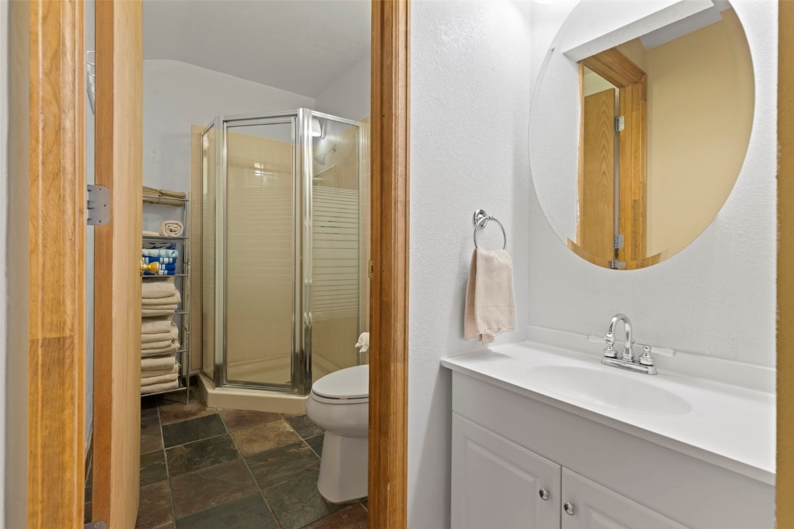 570 Bills Ranch Road, Unit 325 Frisco, CO 80443 - Photo 22 of 30 a bathroom with a granite countertop sink toilet and shower