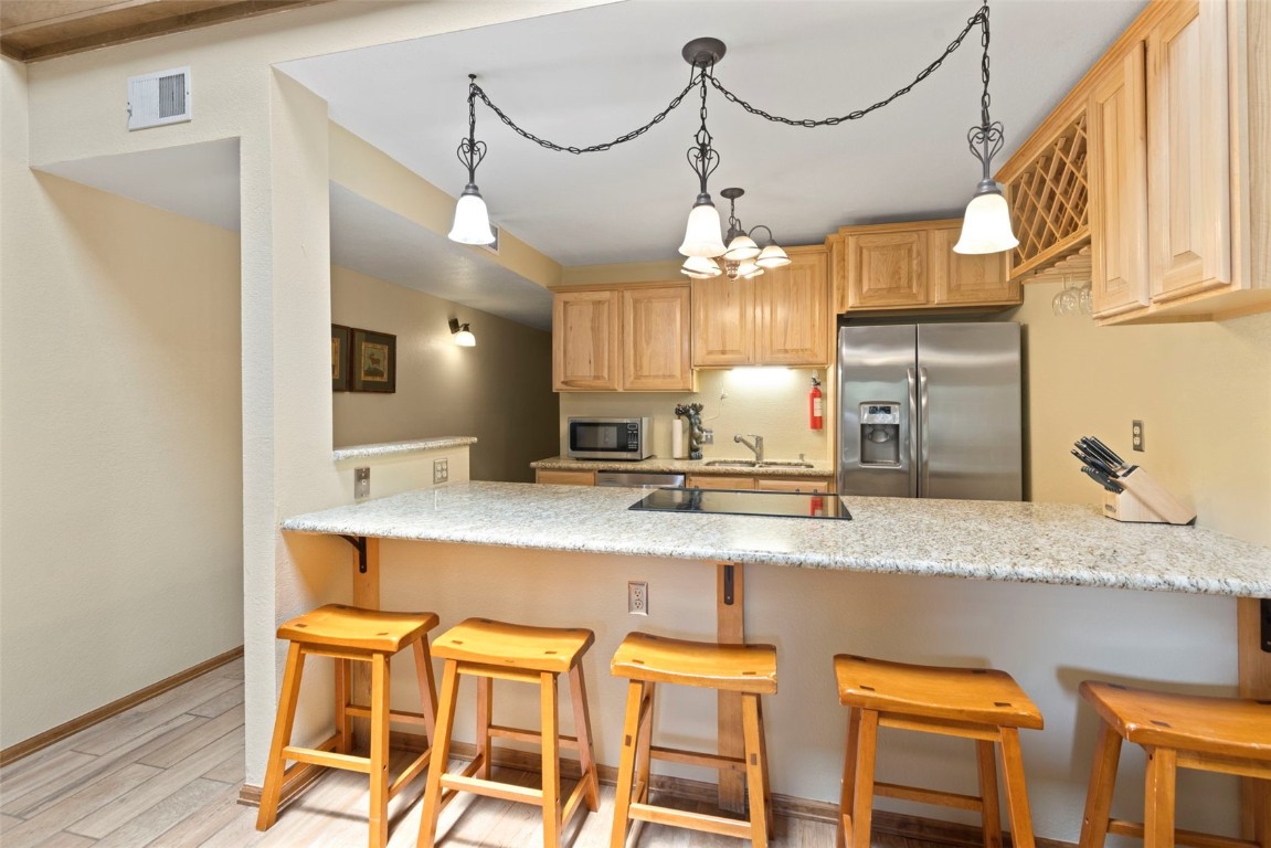 570 Bills Ranch Road, Unit 325 Frisco, CO 80443 - Photo 3 of 30 a large kitchen with a table and chairs in it