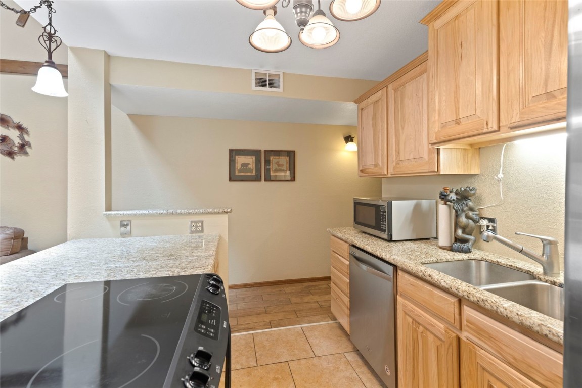 570 Bills Ranch Road, Unit 325 Frisco, CO 80443 - Photo 6 of 30 a kitchen with a sink cabinets and window