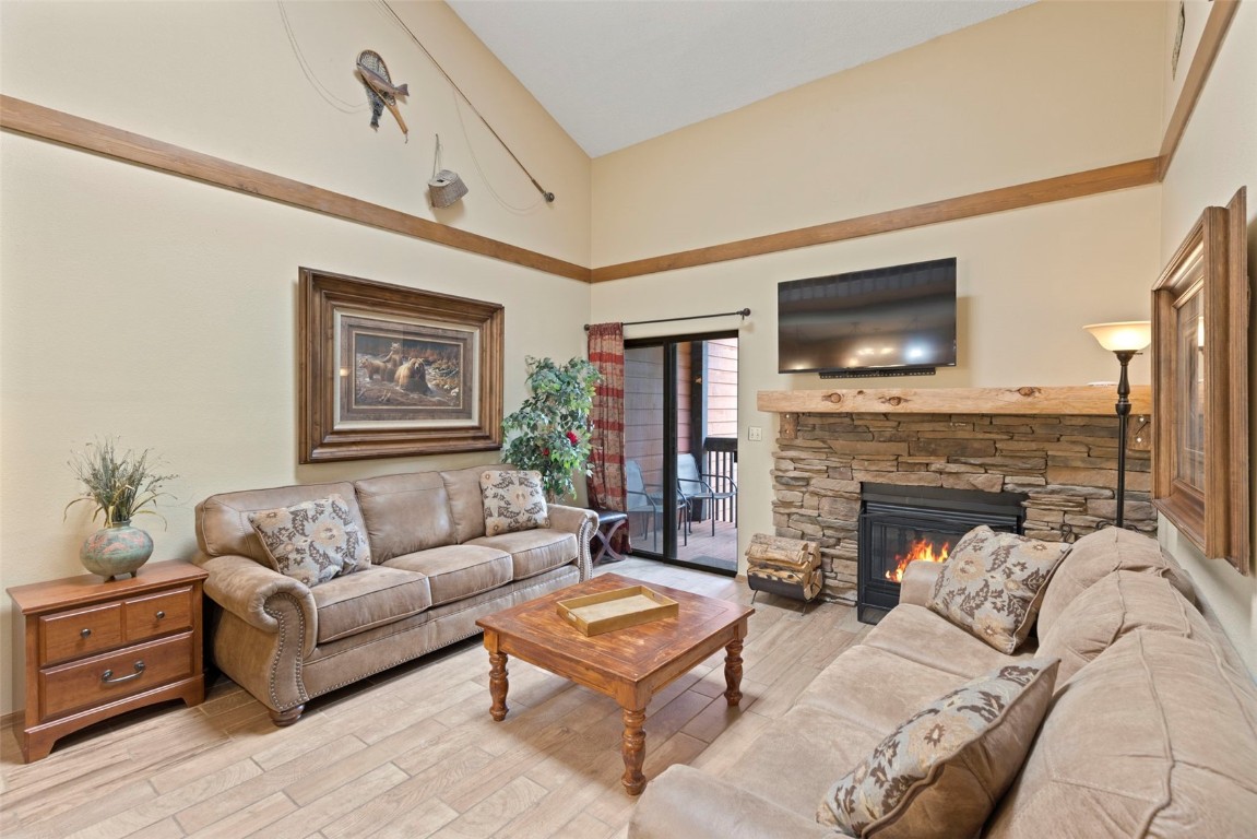 570 Bills Ranch Road, Unit 325 Frisco, CO 80443 - Photo 7 of 30 a living room with furniture a flat screen tv and a fireplace