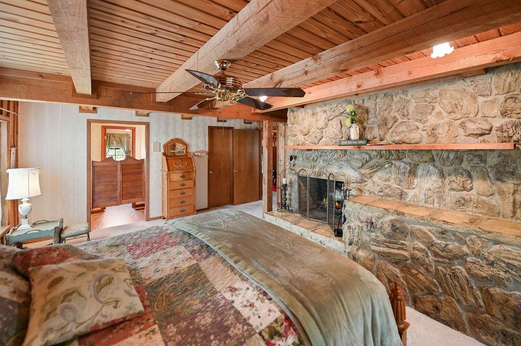 411 Rs County Road 4525 Point, TX 75472 - Photo 5 of 40 a bed room with a bed and a fireplace