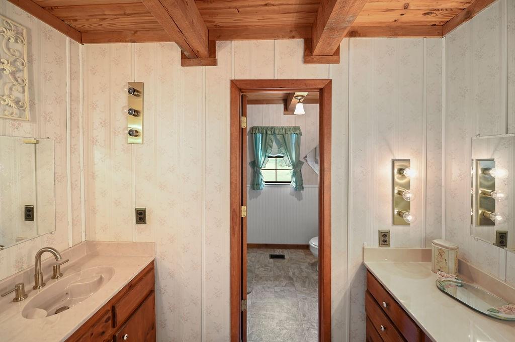 411 Rs County Road 4525 Point, TX 75472 - Photo 6 of 40 a en suite bathroom with a granite countertop sink and a mirror