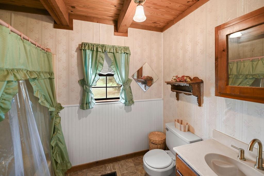 411 Rs County Road 4525 Point, TX 75472 - Photo 7 of 40 a bathroom with a toilet sink and mirror