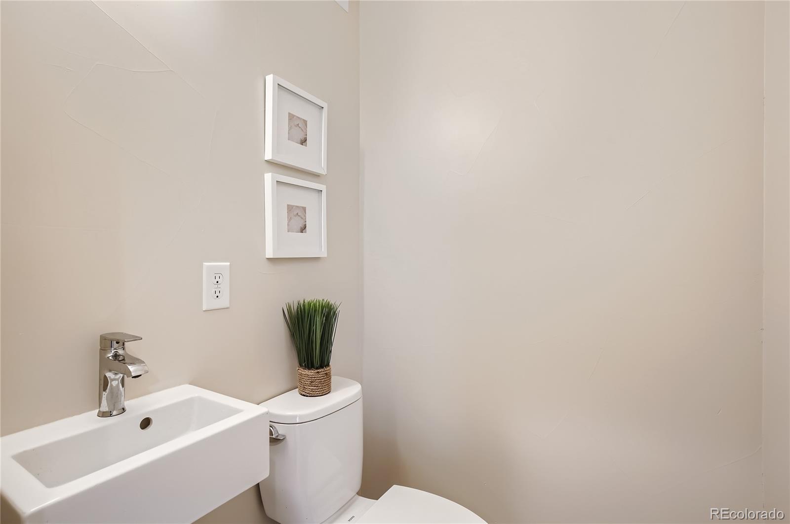 2323 South High Street Denver, CO 80210 - Photo 12 of 21 a bathroom with a toilet a sink and mirror