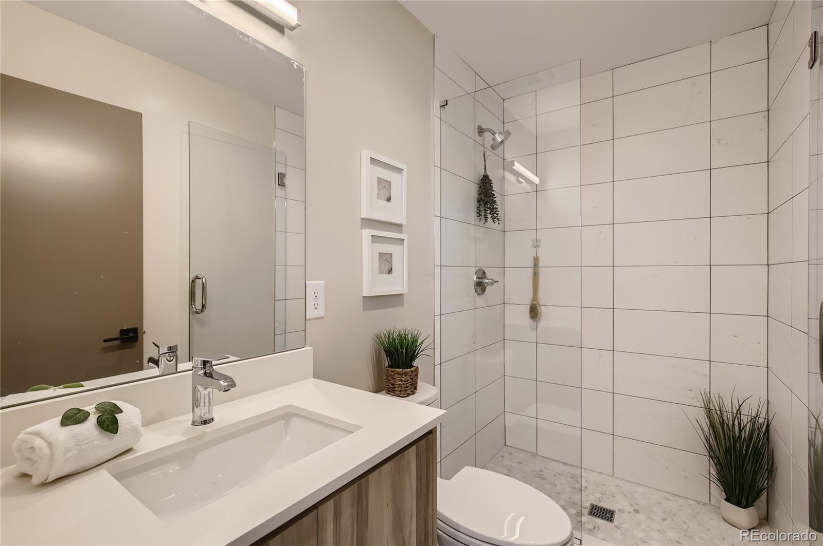 2323 South High Street Denver, CO 80210 - Photo 13 of 21 a bathroom with a sink toilet and shower