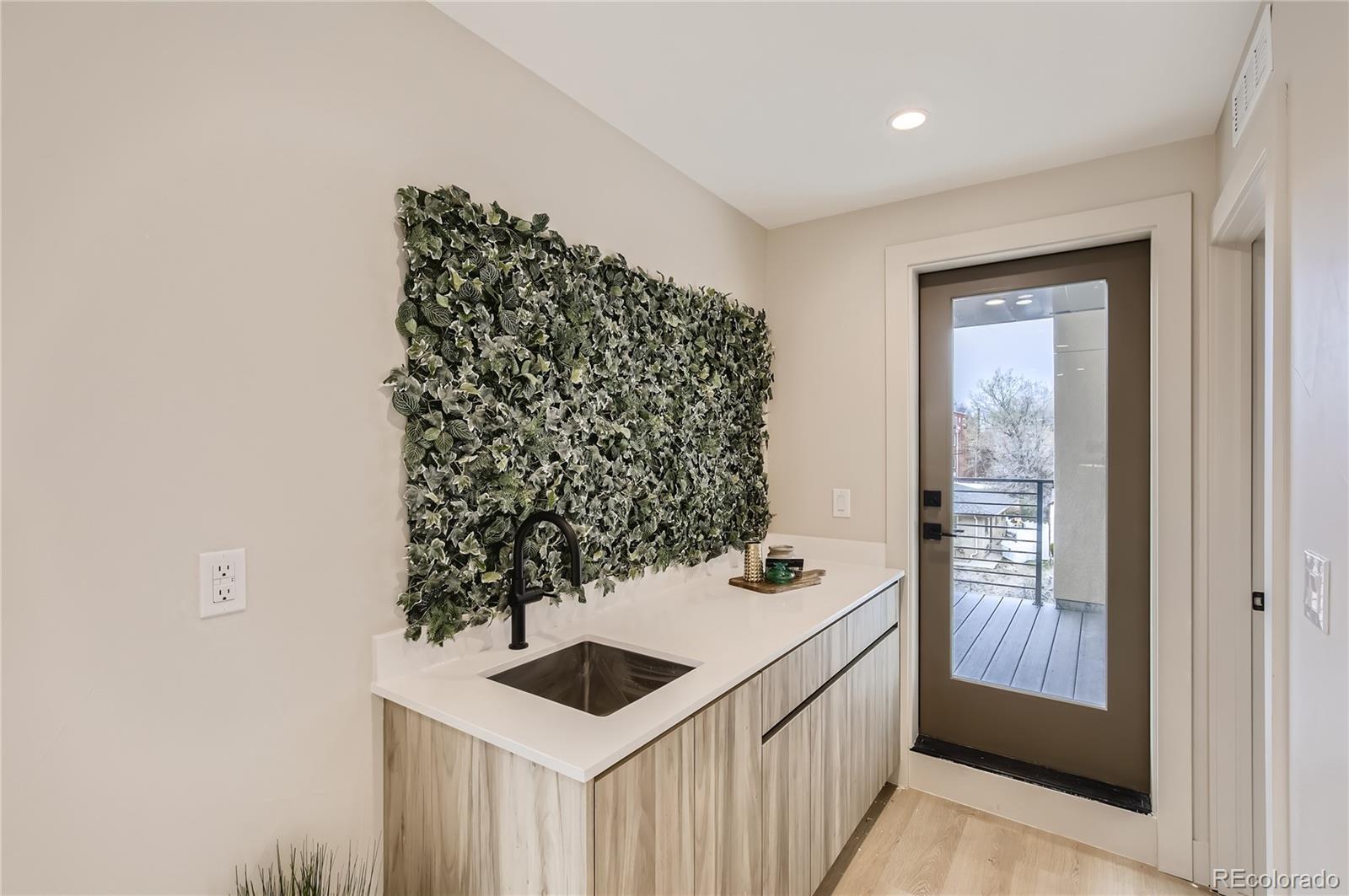 2323 South High Street Denver, CO 80210 - Photo 15 of 21 a kitchen with a sink and a stove with wooden floor