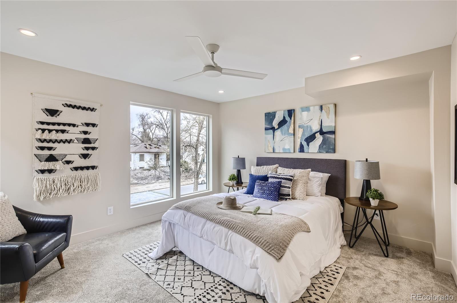 2323 South High Street Denver, CO 80210 - Photo 6 of 21 a bedroom with a large bed and a couch