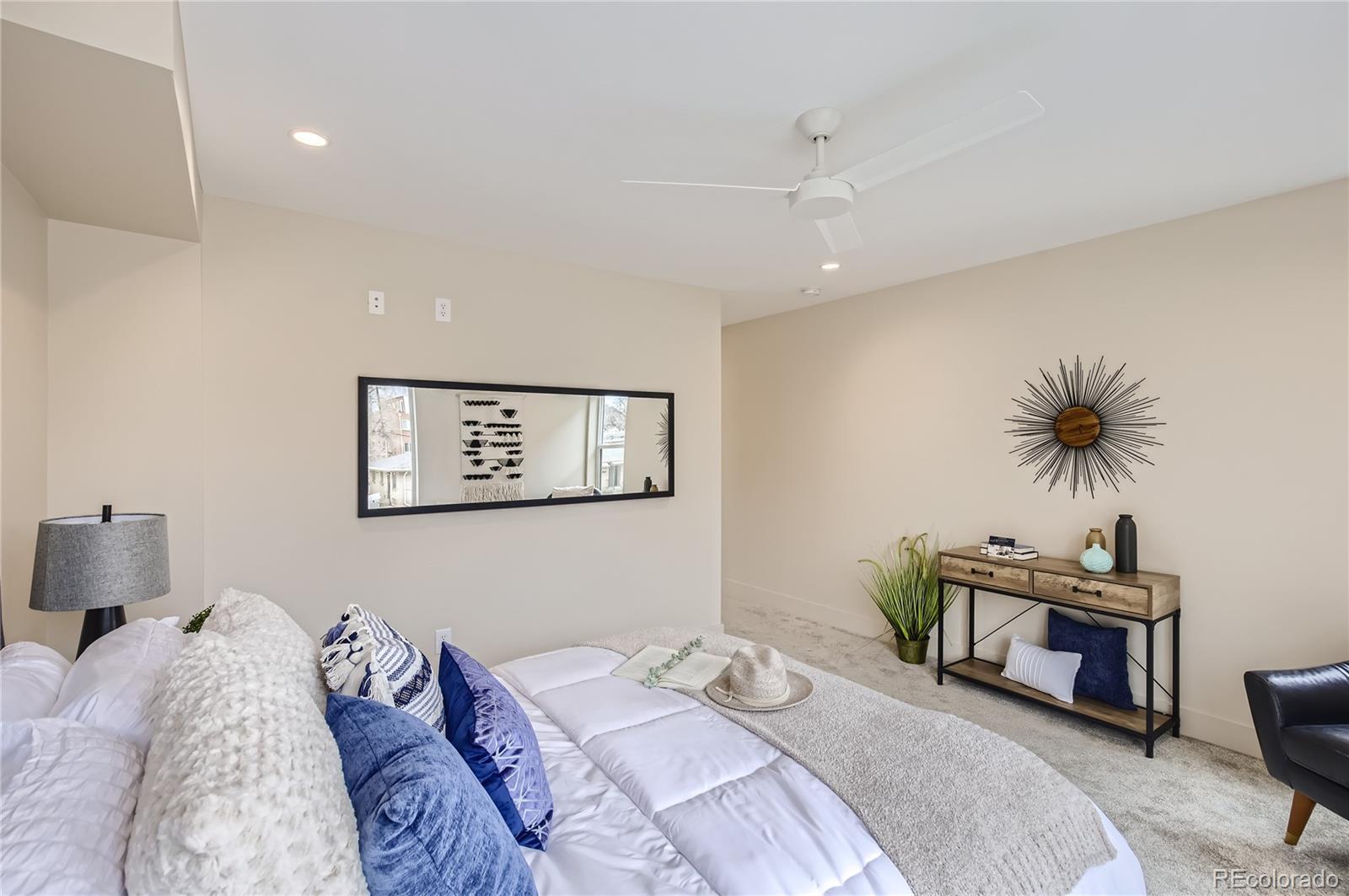 2323 South High Street Denver, CO 80210 - Photo 7 of 21 a bedroom with bed and a potted plant