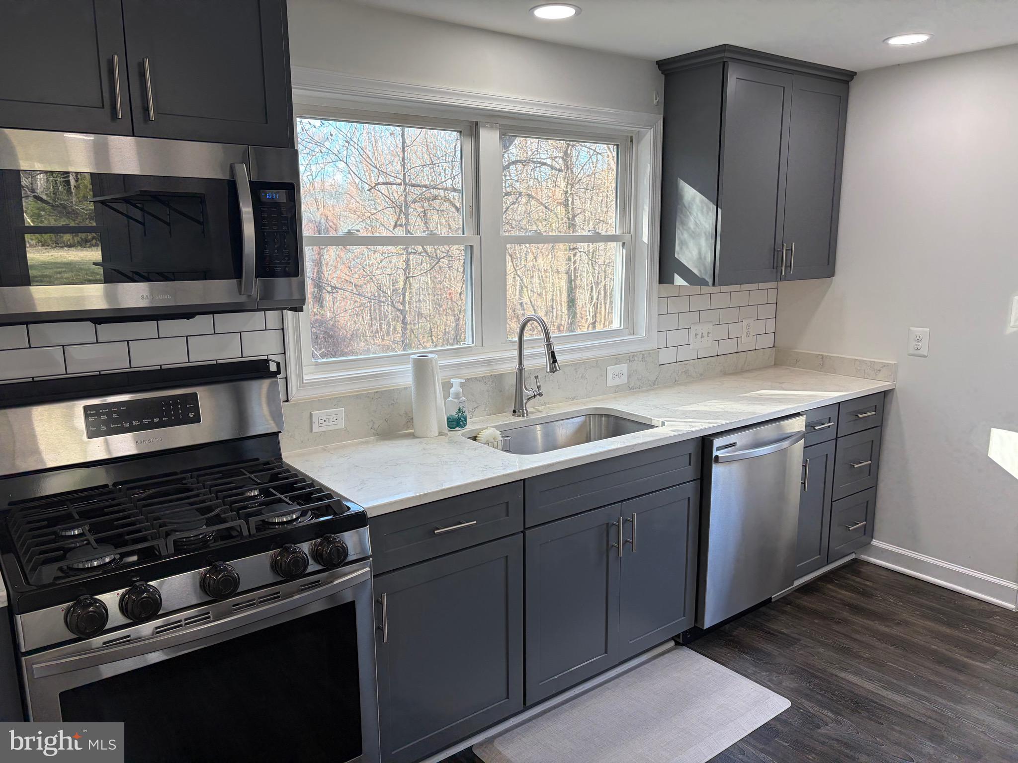 1806 Johnson Road Annapolis, MD 21409 - Photo 24 of 31 a kitchen with granite countertop a stove and a sink