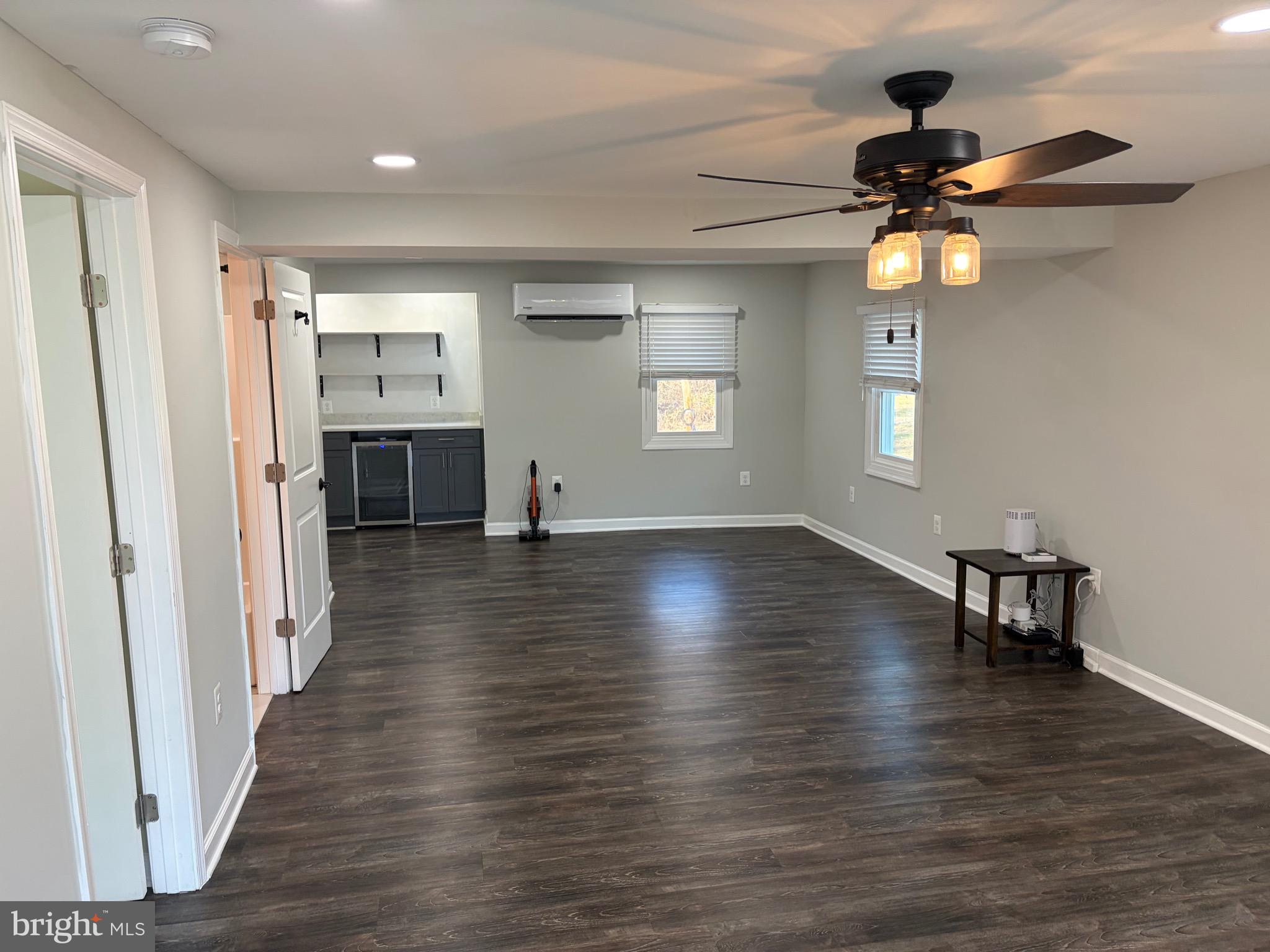 1806 Johnson Road Annapolis, MD 21409 - Photo 29 of 31 an empty room with wooden floor chandelier fan and windows