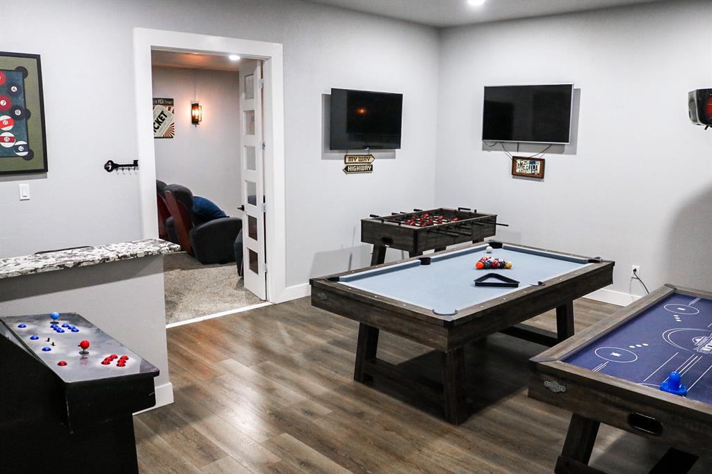 997 Ovilla Road Waxahachie, TX 75167 - Photo 8 of 32 Recreational room featuring wood-finish flooring, light grey wall paint, recessed lighting, and a white interior door with frosted glass panels