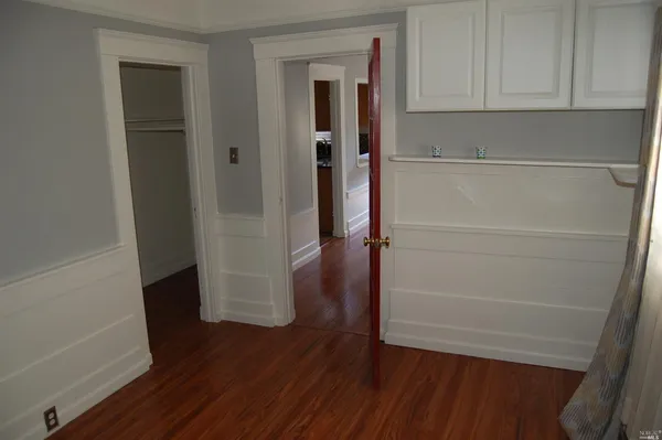 a view of walk in closet with wooden floor