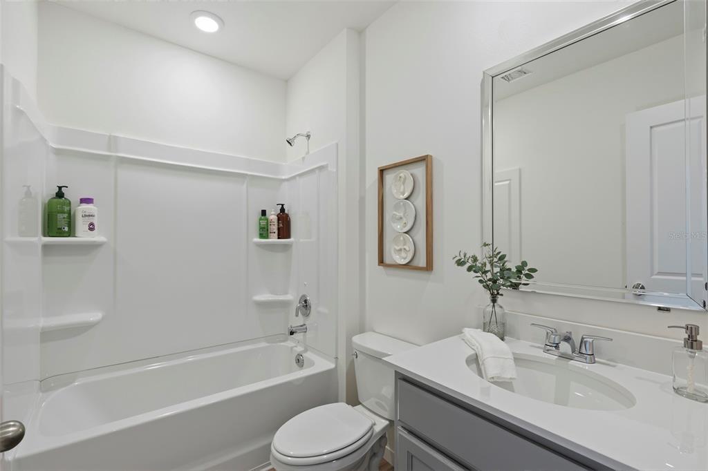 2123 Red Rock Road New Smyrna Beach, FL 32168 - Photo 10 of 14 a bathroom with a sink mirror toilet and bathtub