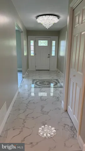 a kitchen with white cabinets a sink dishwasher and a stove with wooden floor