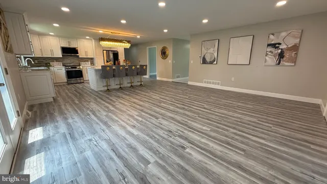 a large kitchen with kitchen island a sink stainless steel appliances and cabinets
