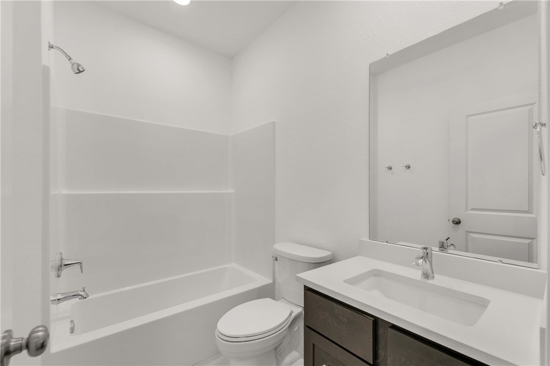 2776 Messenger Way Bryan, TX 77803 - Photo 15 of 16 a bathroom with a sink toilet vanity and shower