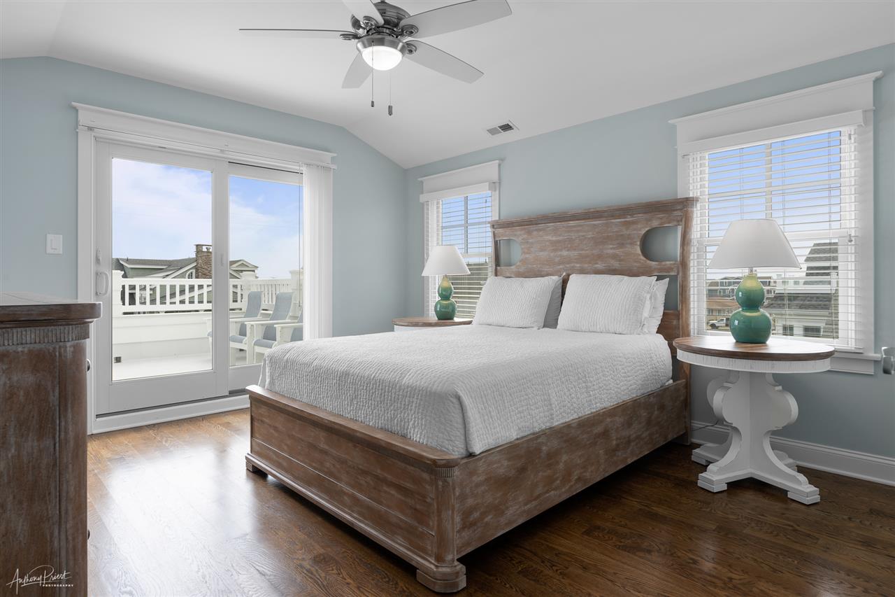 45 West 26th Avalon, NJ 08202 - Photo 11 of 24 a bedroom with a bed a table and a window