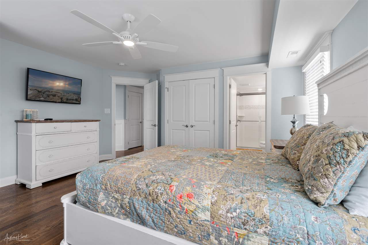 45 West 26th Avalon, NJ 08202 - Photo 12 of 24 a bedroom with a large bed and a flat screen tv