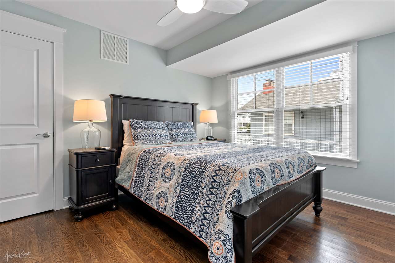 45 West 26th Avalon, NJ 08202 - Photo 13 of 24 a bedroom with a bed and wooden floor