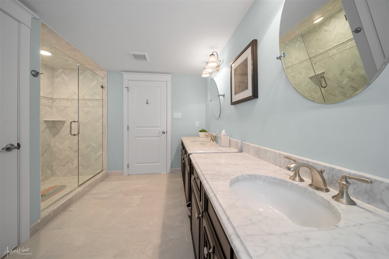 45 West 26th Avalon, NJ 08202 - Photo 16 of 24 a bathroom with a granite countertop sink mirror and shower