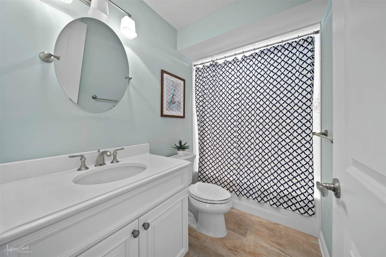 45 West 26th Avalon, NJ 08202 - Photo 18 of 24 a bathroom with a sink a toilet and a mirror