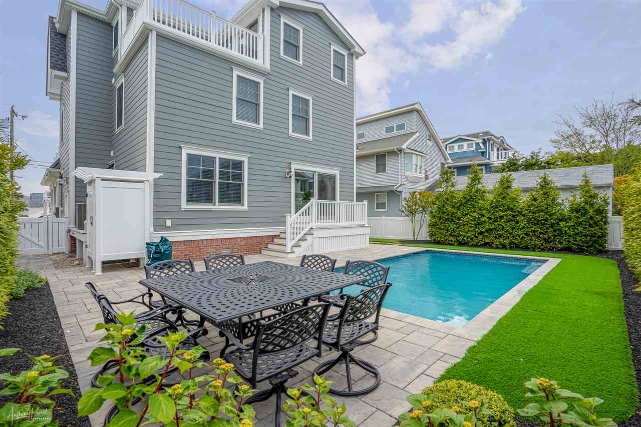 45 West 26th Avalon, NJ 08202 - Photo 22 of 24 a view of a patio with table and chairs and potted plants