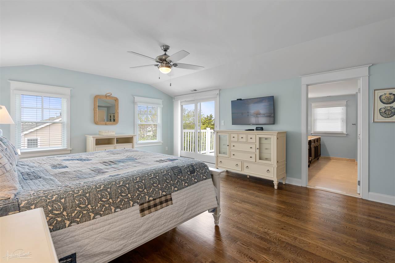 45 West 26th Avalon, NJ 08202 - Photo 9 of 24 a spacious bedroom with a bed and a flat screen tv