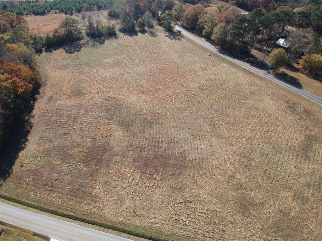 a view of a dry yard with a wooden fence
