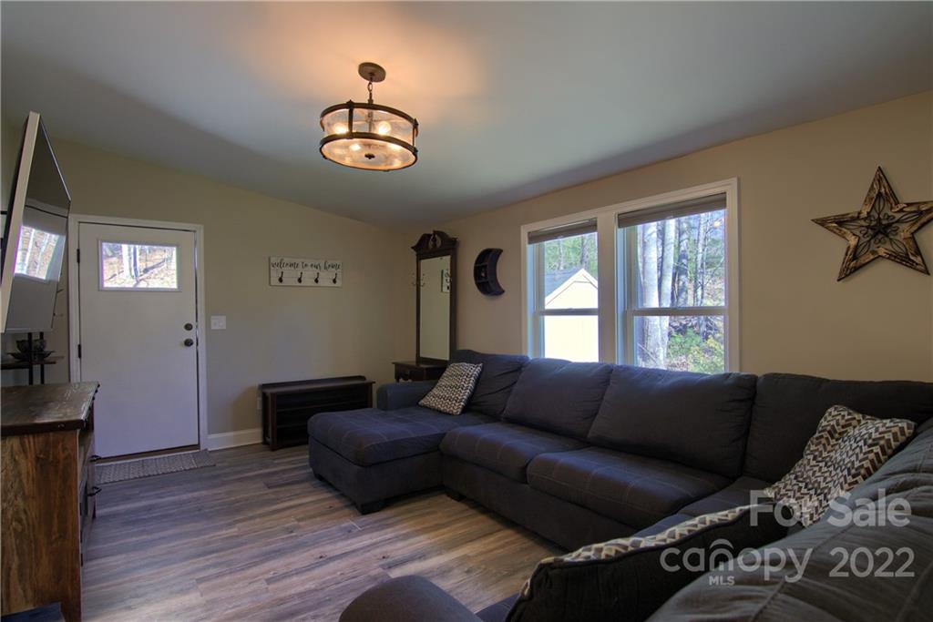 20 Cascade Village Road, Unit 2 Pisgah Forest, NC 28768 - Photo 14 of 36 a living room with furniture and a window