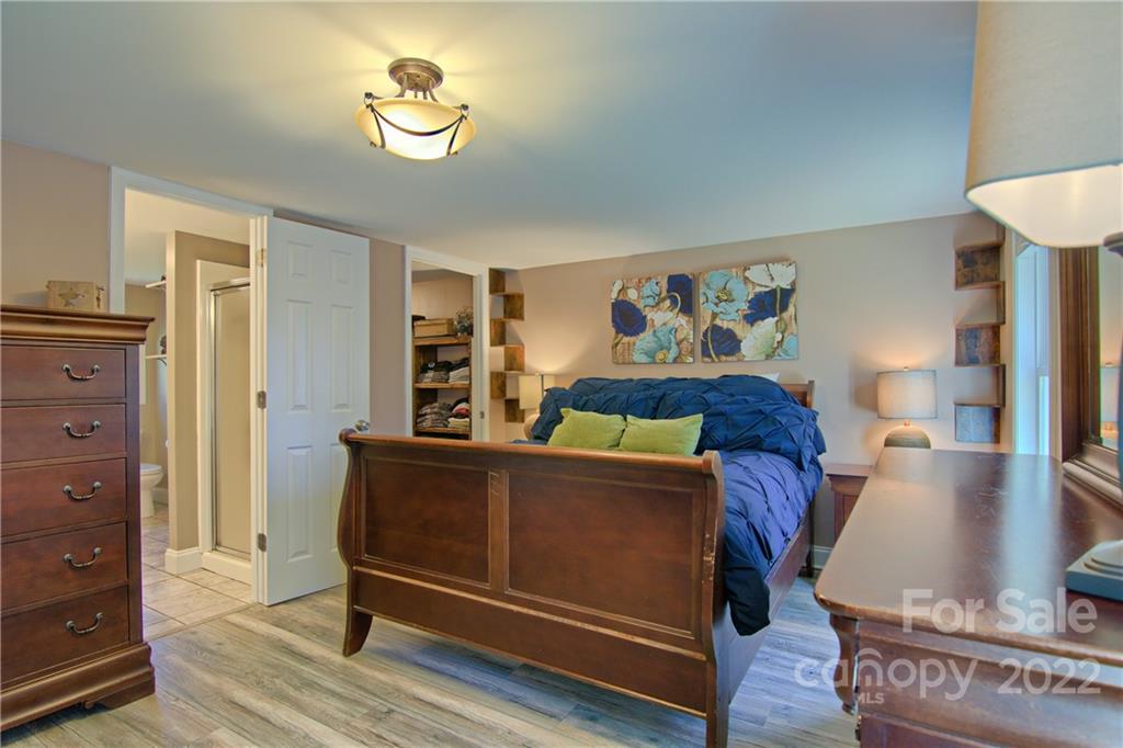 20 Cascade Village Road, Unit 2 Pisgah Forest, NC 28768 - Photo 18 of 36 a bed room with a bed and a lamp