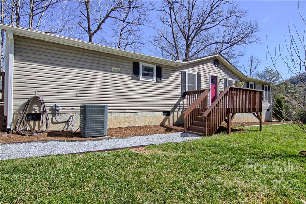 20 Cascade Village Road, Unit 2 Pisgah Forest, NC 28768 - Photo 2 of 36 a view of a house with a yard and furniture