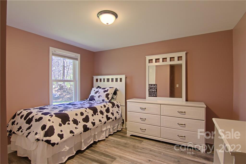 20 Cascade Village Road, Unit 2 Pisgah Forest, NC 28768 - Photo 22 of 36 a bedroom with a bed and a dresser