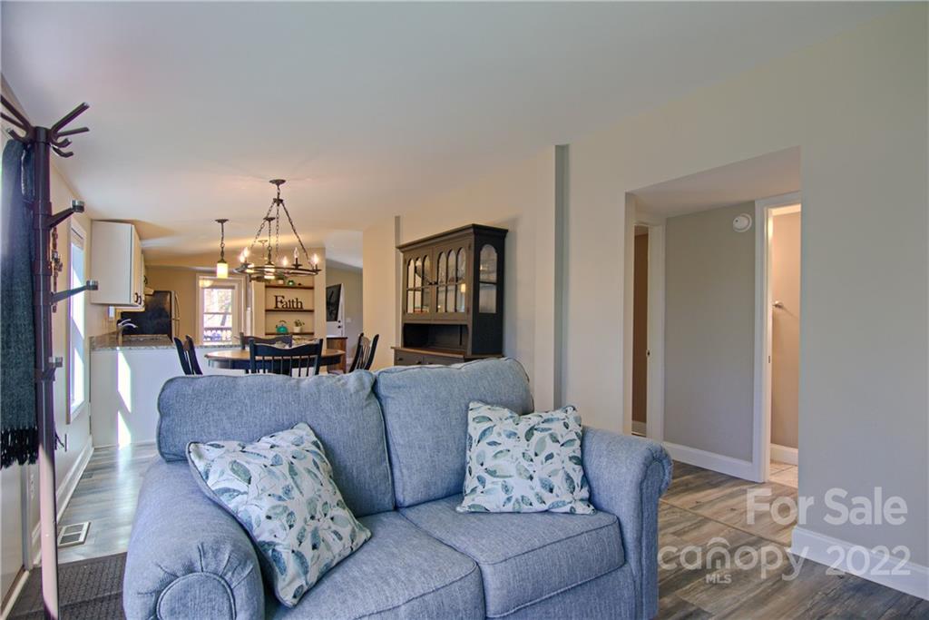 20 Cascade Village Road, Unit 2 Pisgah Forest, NC 28768 - Photo 3 of 36 a living room with furniture and a wooden floor